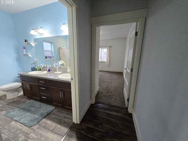 bathroom featuring toilet and vanity