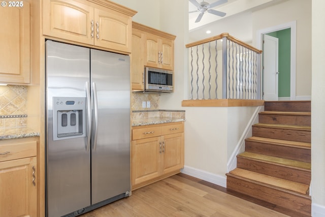 2965 Ingalls Way, Eugene, OR 97405 - kitchen with appliances with stainless steel finishes, light brown cabinetry, light stone counters, light wood-style flooring, and backsplash