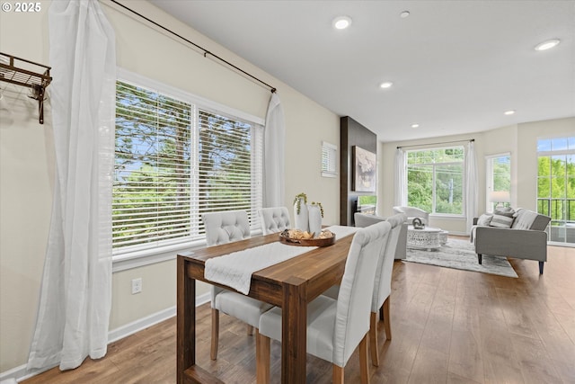 dining area with wood-type flooring, recessed lighting, and baseboards