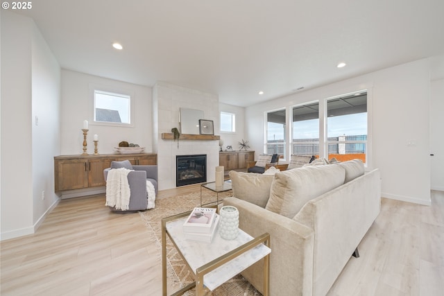 4300 N 12th Way, Ridgefield, WA 98642 - living room featuring light wood finished floors, healthy amount of natural light, a tile fireplace, and recessed lighting