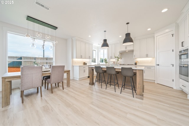 4300 N 12th Way, Ridgefield, WA 98642 - kitchen with light countertops, tasteful backsplash, white cabinetry, a kitchen breakfast bar, and recessed lighting