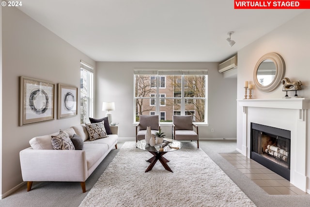 carpeted living room with a wall mounted air conditioner, healthy amount of natural light, a fireplace with flush hearth, and baseboards