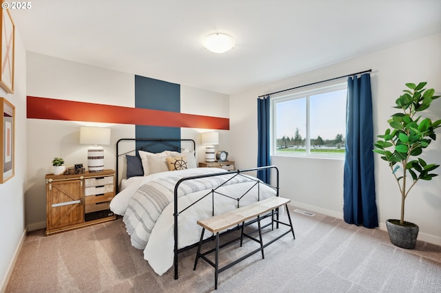 bedroom with visible vents, carpet flooring, and baseboards