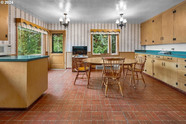 kitchen featuring decorative light fixtures and an inviting chandelier