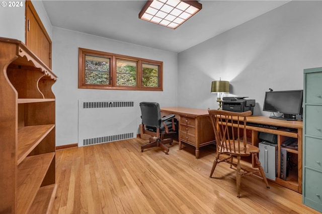 home office with radiator and light hardwood / wood-style floors