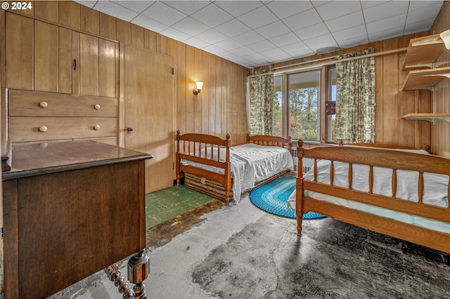 bedroom featuring wooden walls