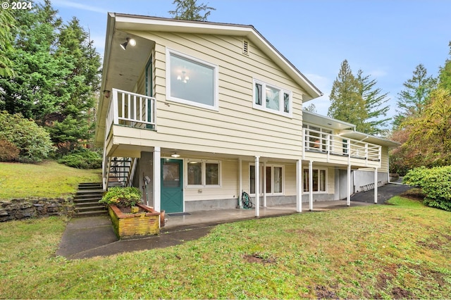 back of property with a patio area and a yard