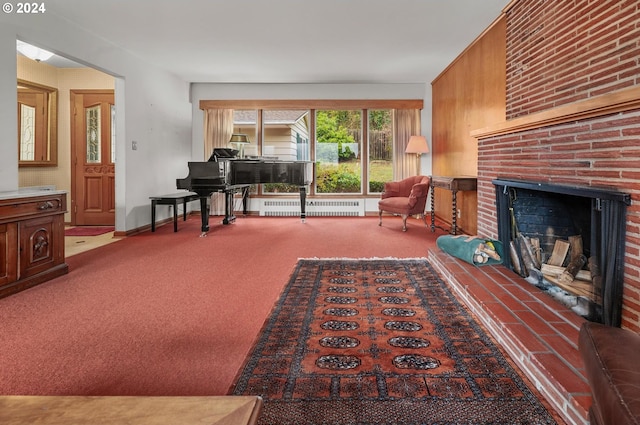 sitting room with radiator heating unit, carpet floors, a brick fireplace, and wood walls