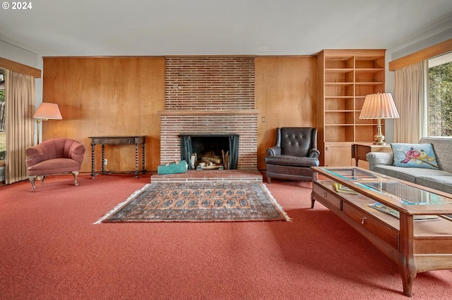 carpeted living room featuring built in features, a fireplace, and wooden walls