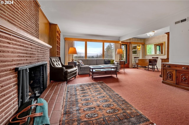 carpeted living room with a brick fireplace