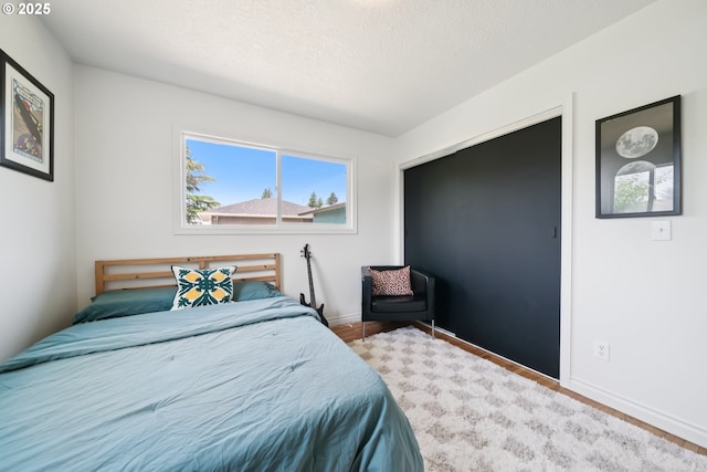324 NE 108th Pl, Portland, OR 97220 - bedroom featuring a textured ceiling and wood finished floors