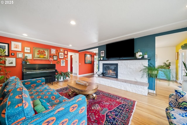 324 NE 108th Pl, Portland, OR 97220 - living room with wood finished floors, a stone fireplace, and recessed lighting