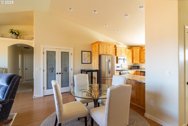 2260 NE 8th St, Hermiston, OR 97838 - dining area with vaulted ceiling, light wood finished floors, french doors, recessed lighting, and arched walkways
