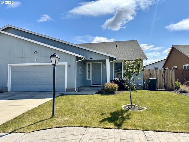 view of front of property with a garage, driveway, and roof with shingles