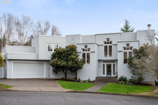 art deco house with a front lawn and driveway