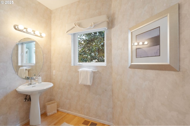 bathroom featuring visible vents, baseboards, and wood finished floors