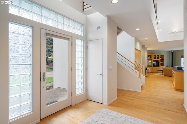 entryway featuring visible vents, recessed lighting, stairway, light wood-style floors, and baseboards