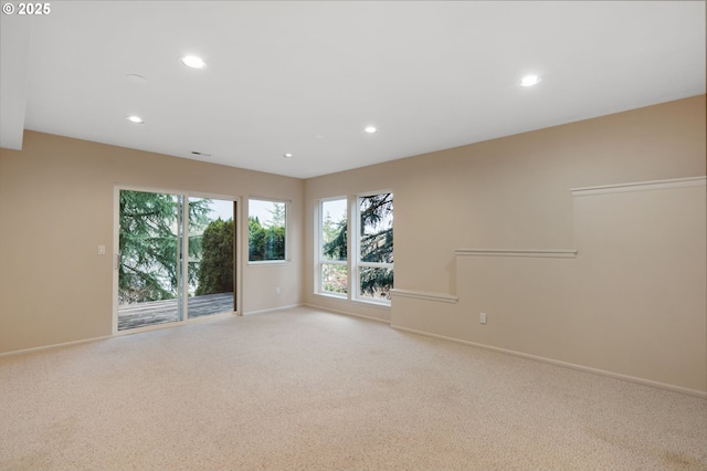 spare room featuring recessed lighting, baseboards, light carpet, and visible vents