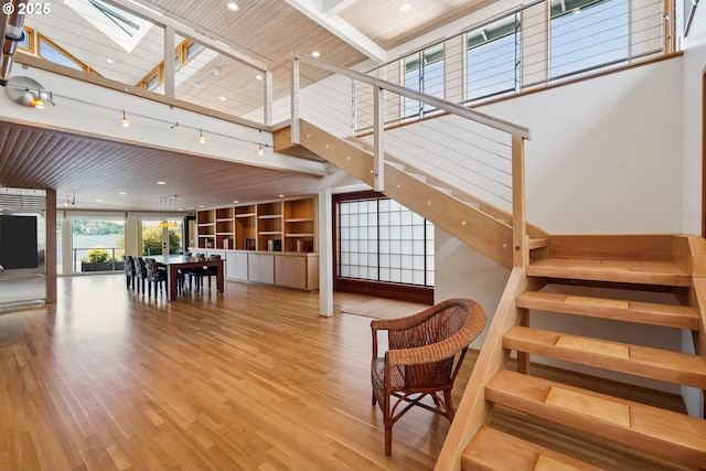 6901 SE Oaks Park Way Unit F, Portland, OR 97202 - stairway featuring a skylight, a high ceiling, wood finished floors, wooden ceiling, and recessed lighting