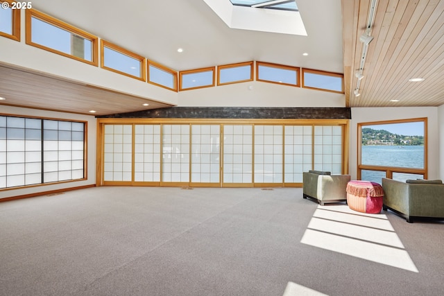 6901 SE Oaks Park Way Unit F, Portland, OR 97202 - living room with carpet flooring, a skylight, recessed lighting, a water view, and high vaulted ceiling