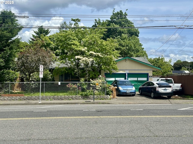 1218 SE 162nd Ave, Portland, OR 97233 - obstructed view of property featuring an attached garage and driveway