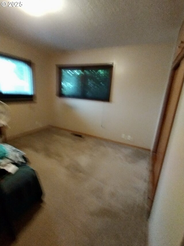 1218 SE 162nd Ave, Portland, OR 97233 - unfurnished living room with carpet floors and baseboards