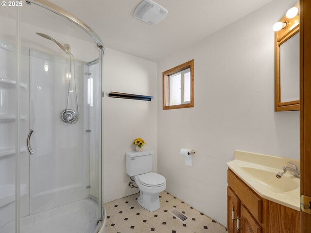 bathroom with visible vents, toilet, tile patterned floors, vanity, and a shower stall