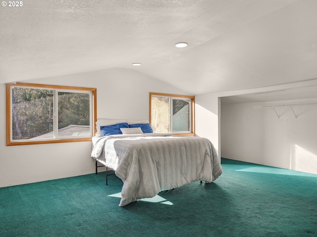 bedroom featuring carpet floors, a textured ceiling, and lofted ceiling