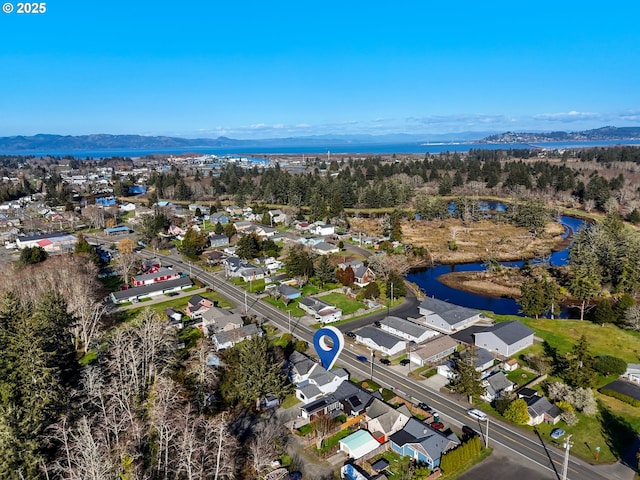 birds eye view of property featuring a residential view and a water and mountain view