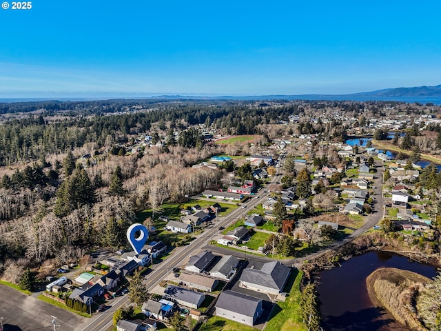 bird's eye view with a water view and a view of trees