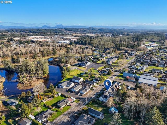 drone / aerial view featuring a residential view and a water and mountain view