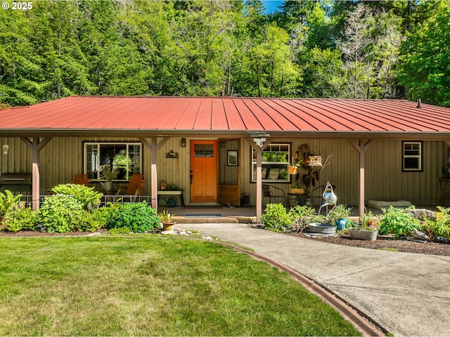 51256 Salmon Gulch Rd, Myrtle Point, OR 97458 - view of front of property with covered porch, a front lawn, a metal roof, and a standing seam roof