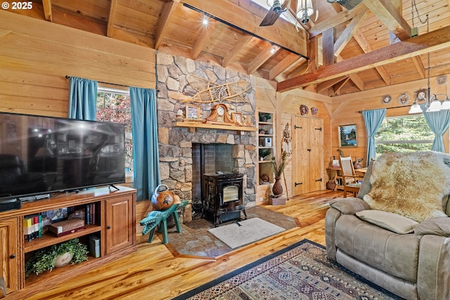51256 Salmon Gulch Rd, Myrtle Point, OR 97458 - living room with wooden ceiling, a wood stove, wood finished floors, and wooden walls