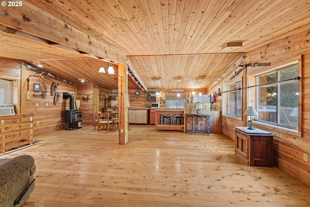 51256 Salmon Gulch Rd, Myrtle Point, OR 97458 - living area with a wood stove, wooden ceiling, wooden walls, light wood-style floors, and vaulted ceiling