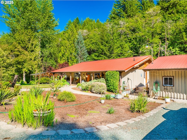 51256 Salmon Gulch Rd, Myrtle Point, OR 97458 - view of front of property with board and batten siding, a porch, and a metal roof