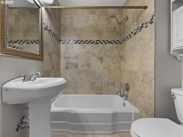 full bath featuring  shower combination, toilet, and tile patterned floors