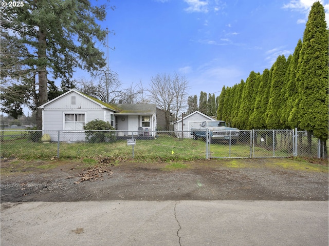 view of front facade with a fenced front yard and a gate