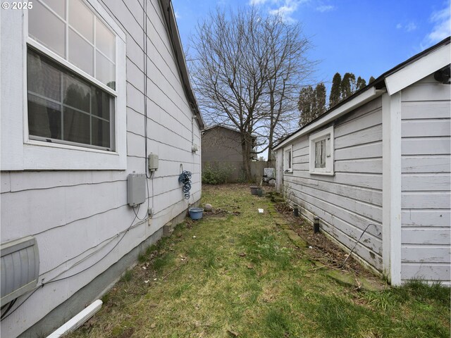 view of home's exterior with a yard and fence