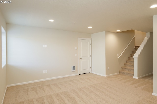 spare room featuring light carpet