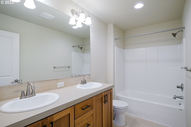 full bathroom featuring tile patterned flooring, vanity, shower / washtub combination, tasteful backsplash, and toilet