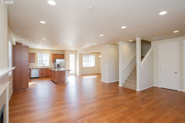 kitchen with light hardwood / wood-style floors, a center island, and appliances with stainless steel finishes