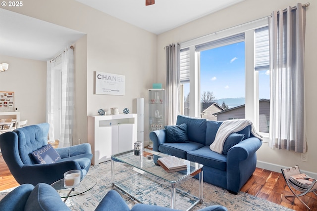 living room featuring hardwood / wood-style floors and ceiling fan