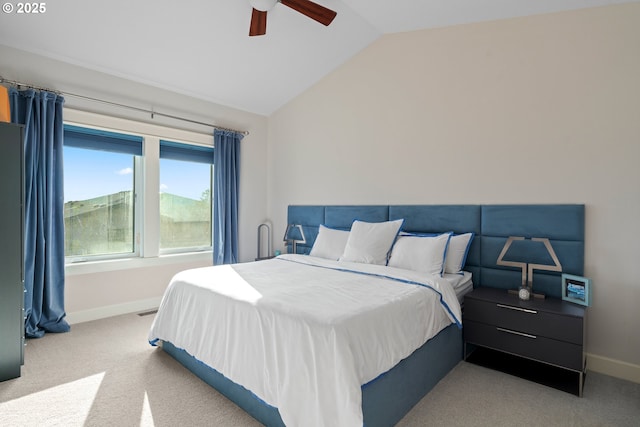 carpeted bedroom featuring ceiling fan, visible vents, baseboards, and vaulted ceiling