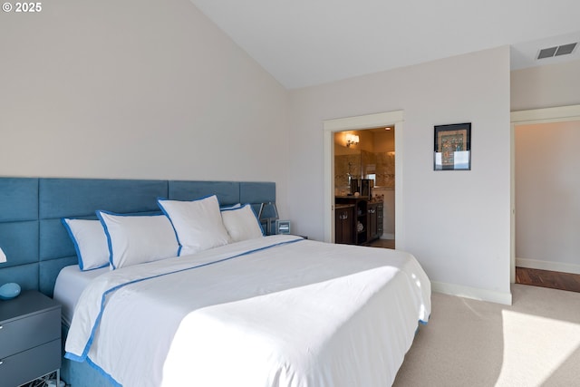 bedroom featuring baseboards, visible vents, connected bathroom, lofted ceiling, and carpet floors