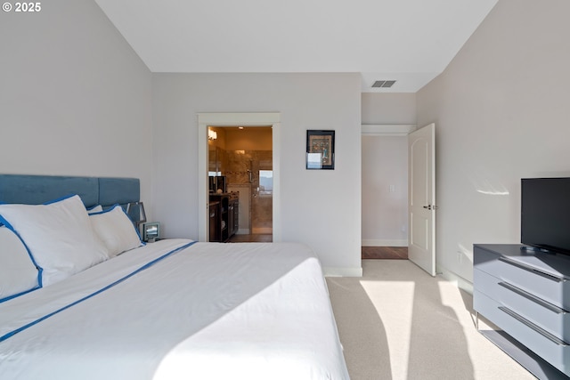 bedroom featuring baseboards, visible vents, connected bathroom, and light colored carpet