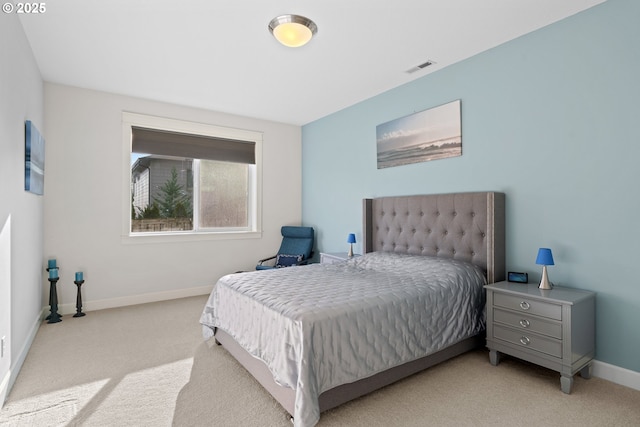 carpeted bedroom with visible vents and baseboards