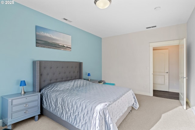 carpeted bedroom featuring visible vents and baseboards