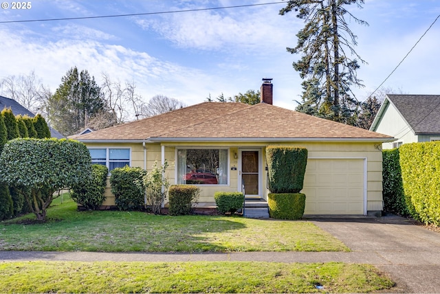 view of front of property with a garage and a front lawn