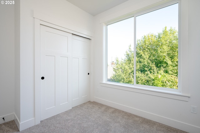319 N Holland St, Portland, OR 97217 - unfurnished bedroom featuring carpet floors, baseboards, and a closet