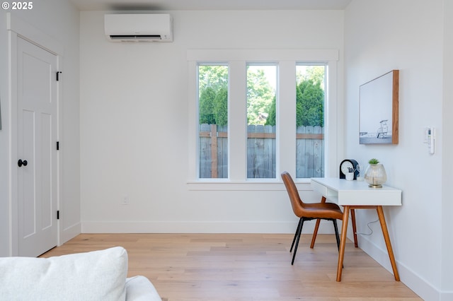 319 N Holland St, Portland, OR 97217 - home office featuring an AC wall unit, light wood-type flooring, and baseboards